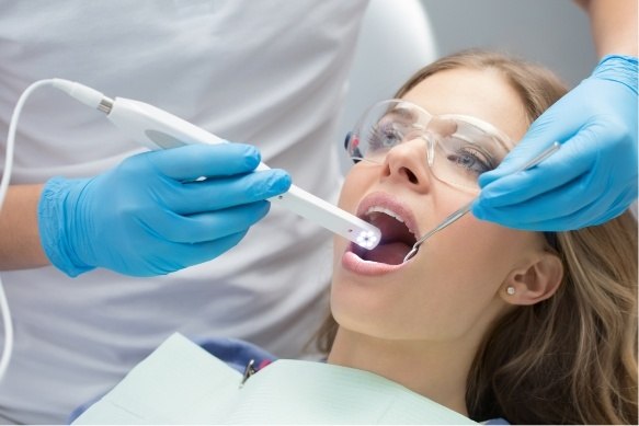 Dentist using intraoral camera to capture smile images